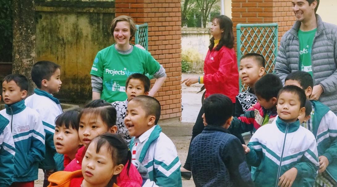 Projects Abroad volunteers play an educational game with children outside a care centre in Vietnam. Volunteers play with a group of children outside a care centre at their Childcare placement in Vietnam.